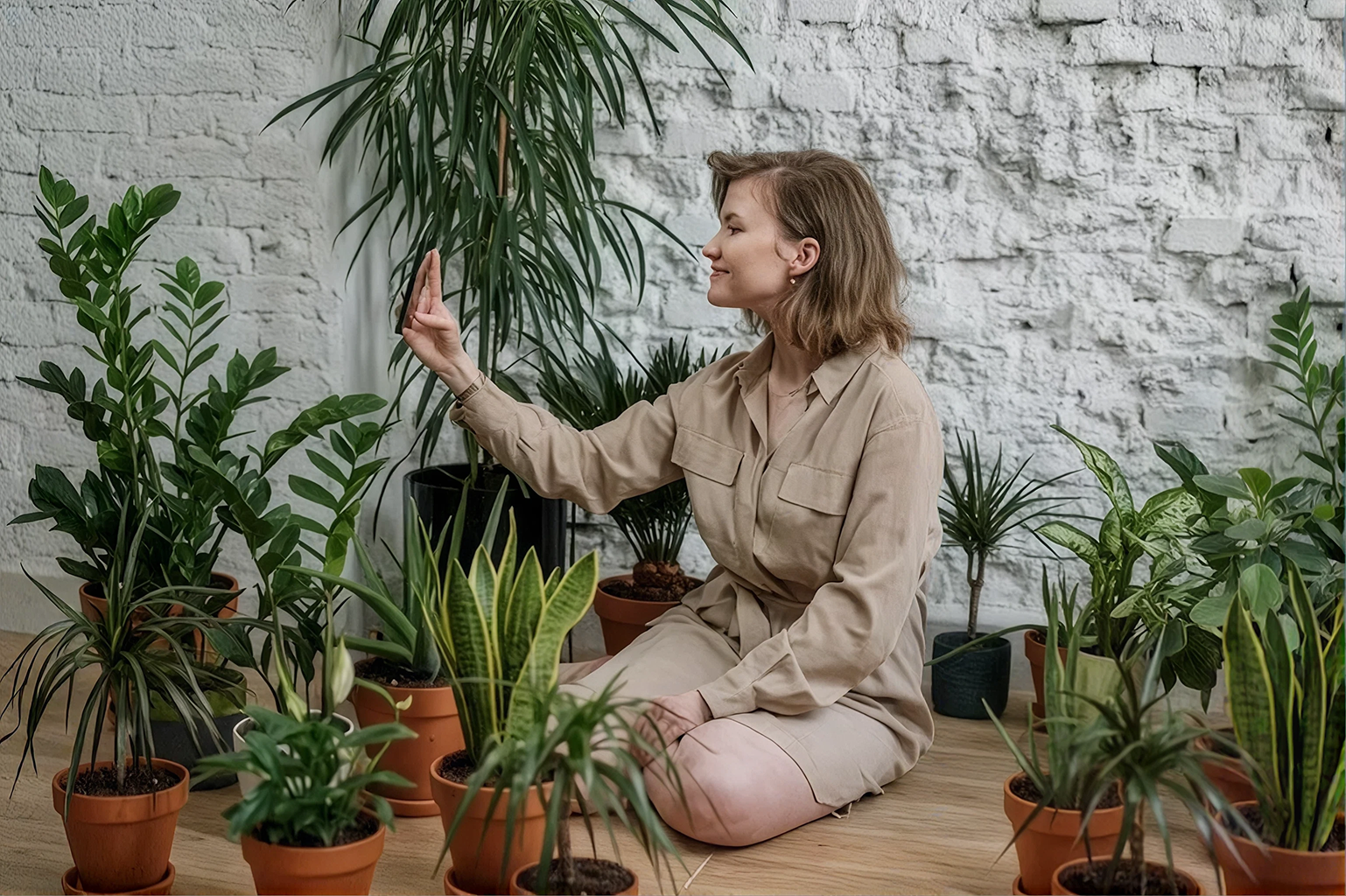 Woman taking selfie among potted plants indoors.